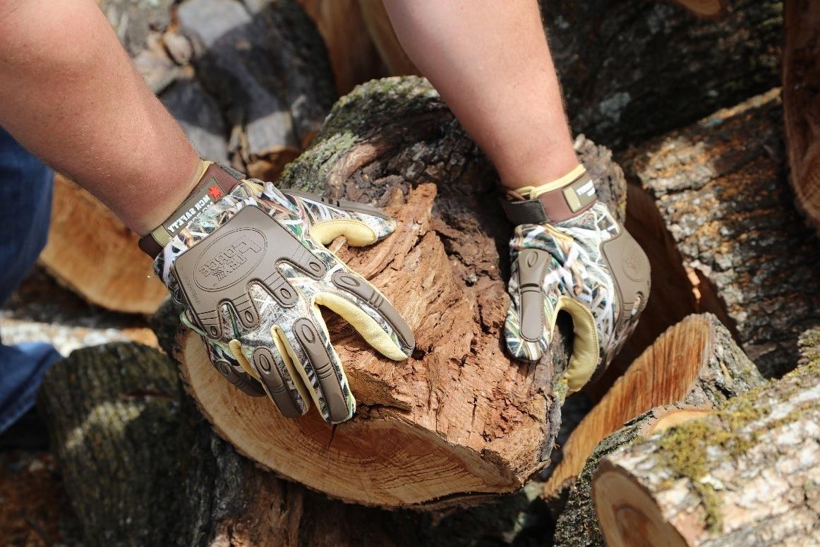 Camo Gloves holding wood